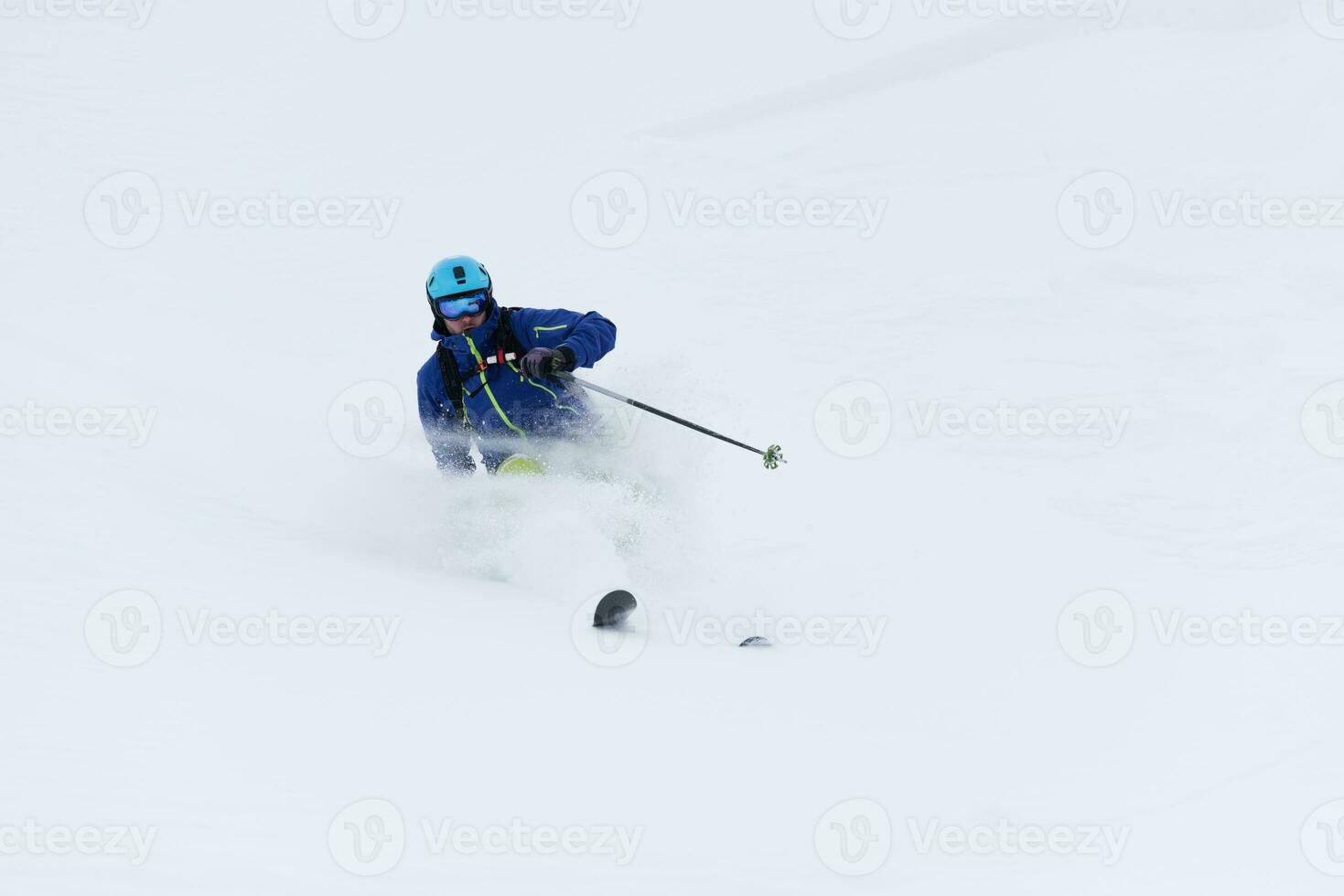 freeride skier skiing in deep powder snow photo