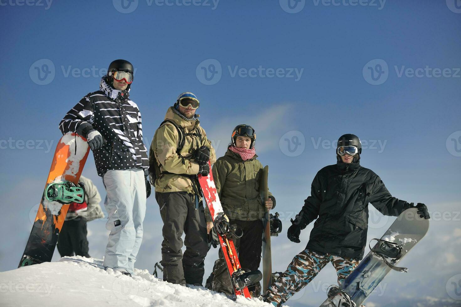snowboarders group relaxing and enjoy sun photo