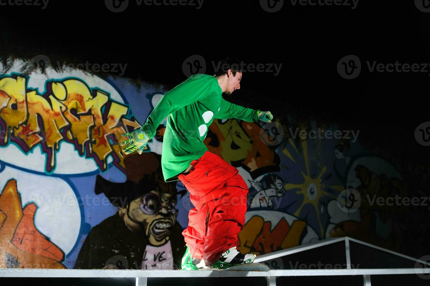 freestyle snowboarder jump in air at night photo