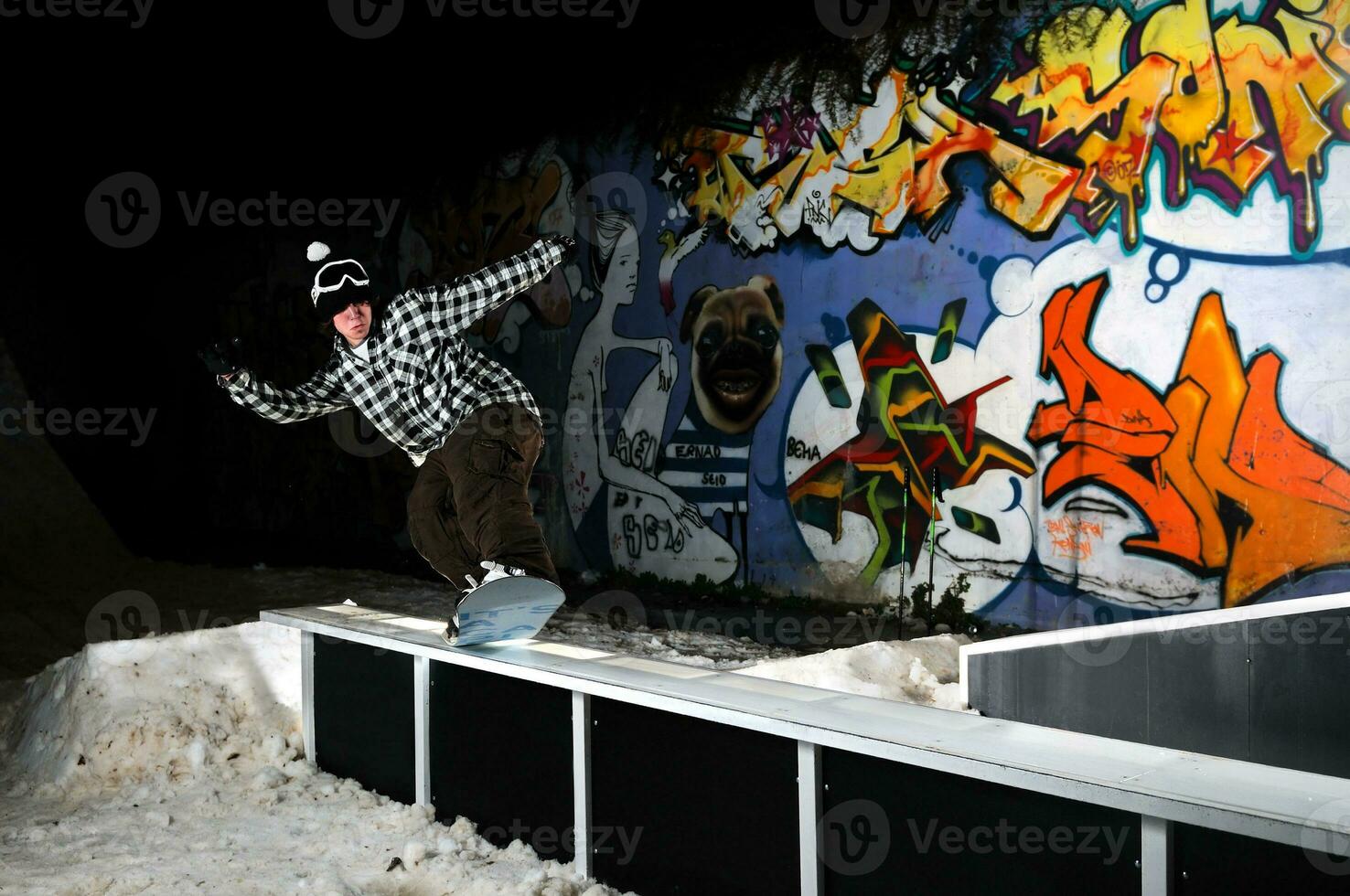 freestyle snowboarder jump in air at night photo