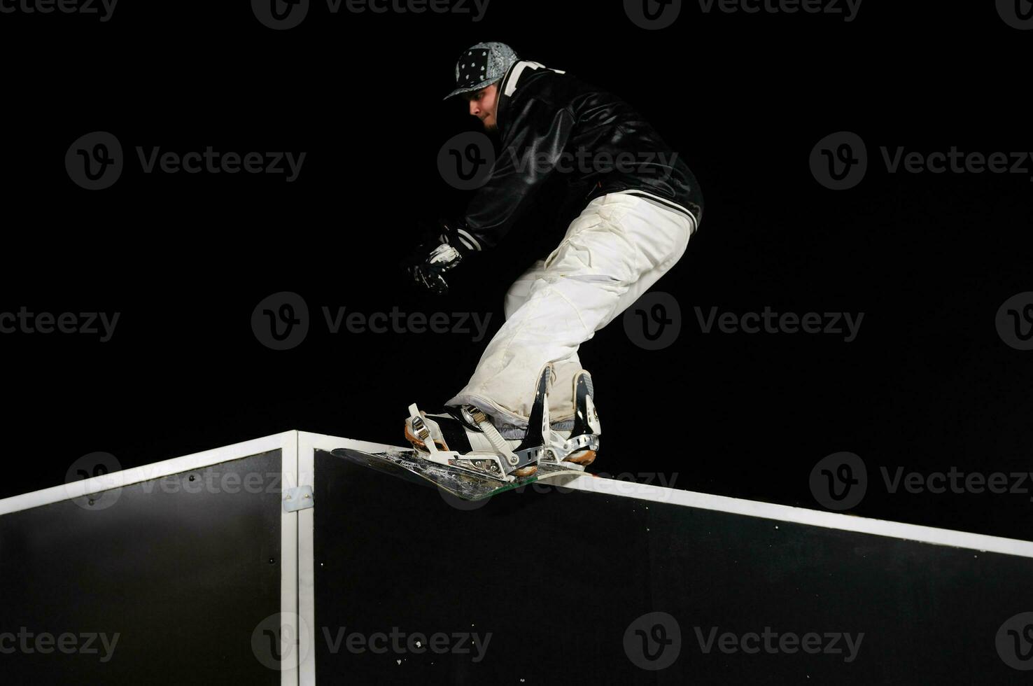 freestyle snowboarder jump in air at night photo
