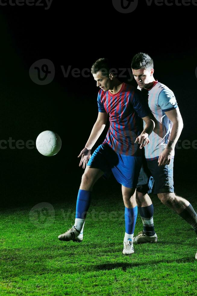 football players in competition for the ball photo