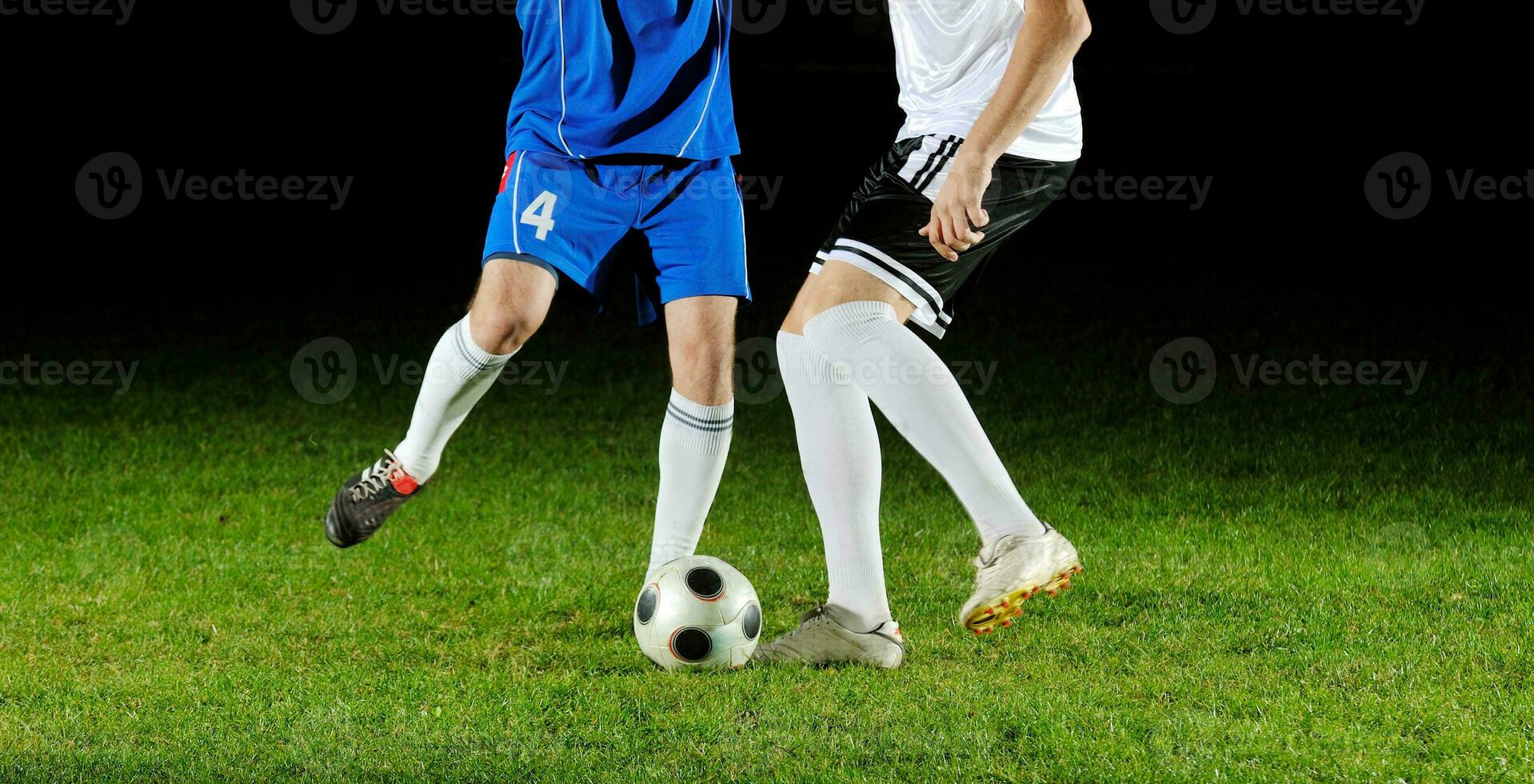 football players in action for the ball photo