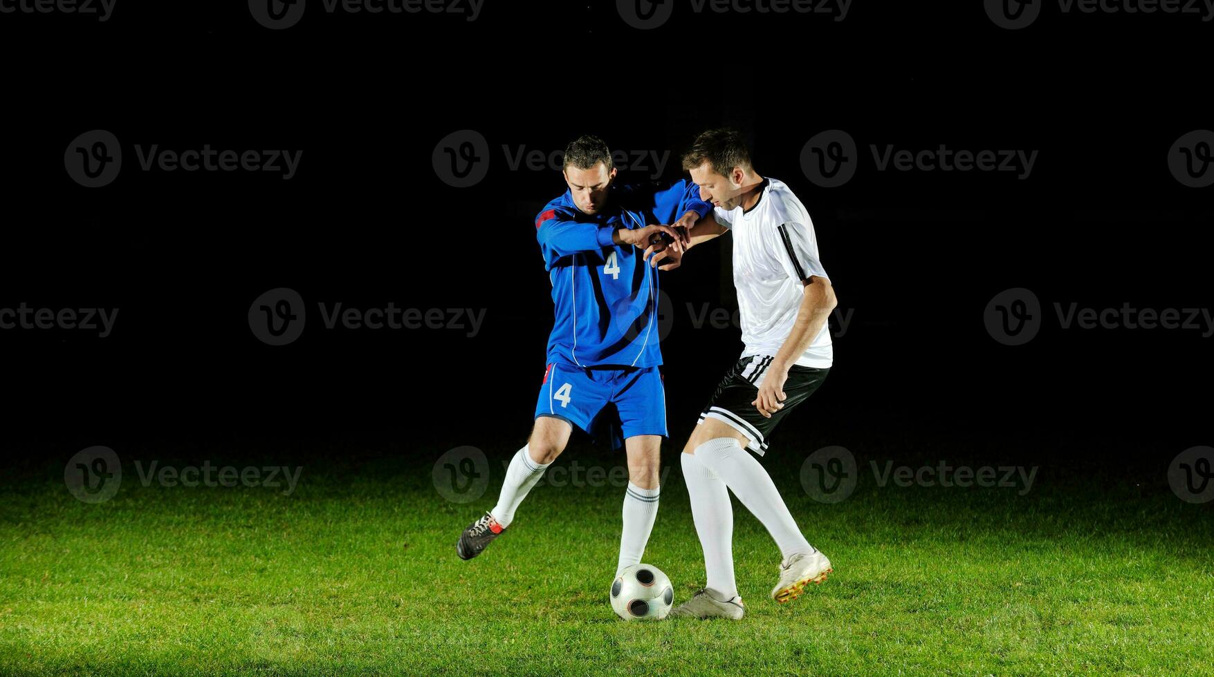 football players in action for the ball photo