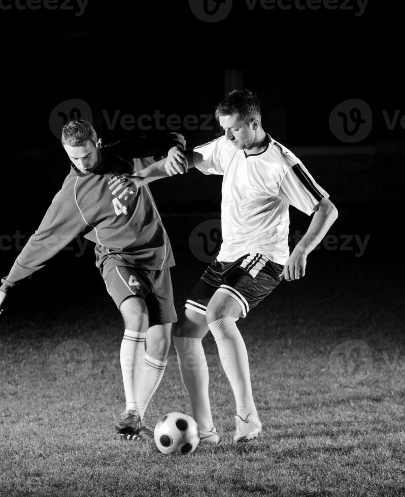 football players in action for the ball photo