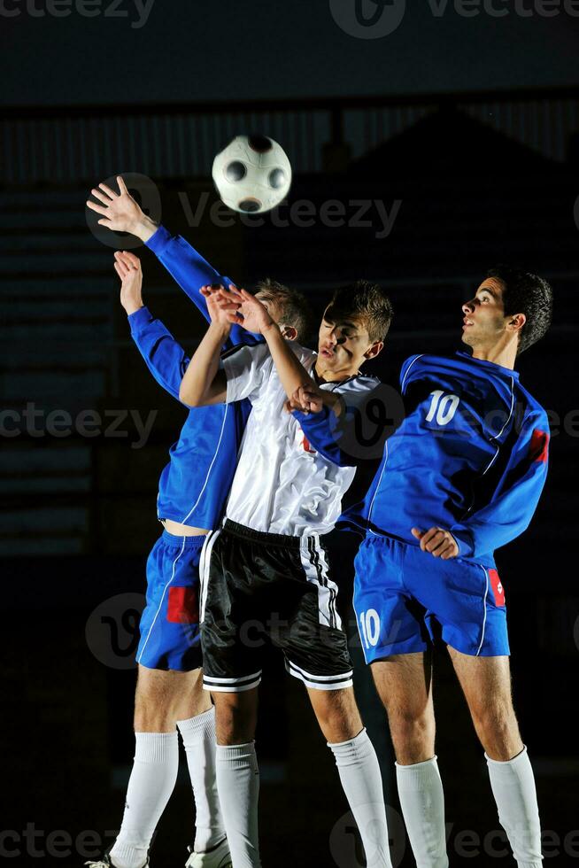 football players in action for the ball photo