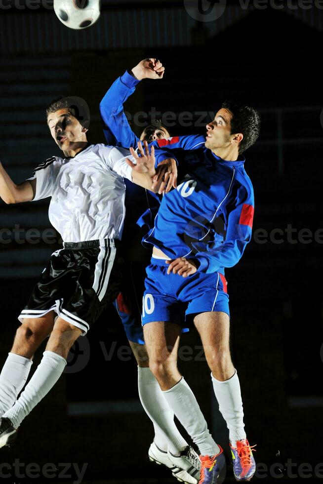 football players in action for the ball photo