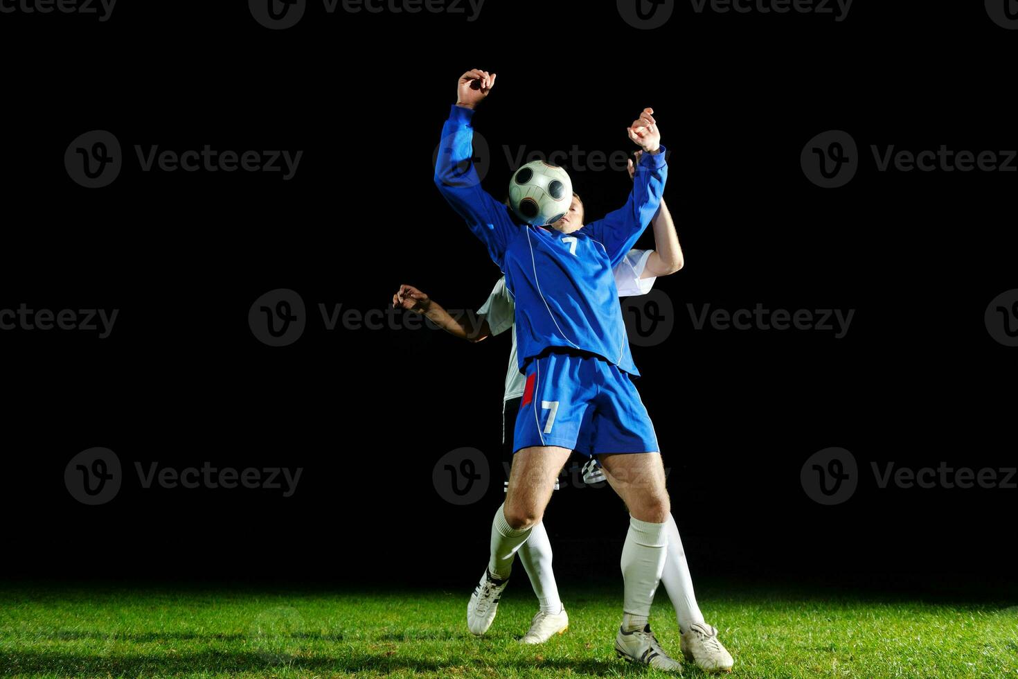 football players in action for the ball photo