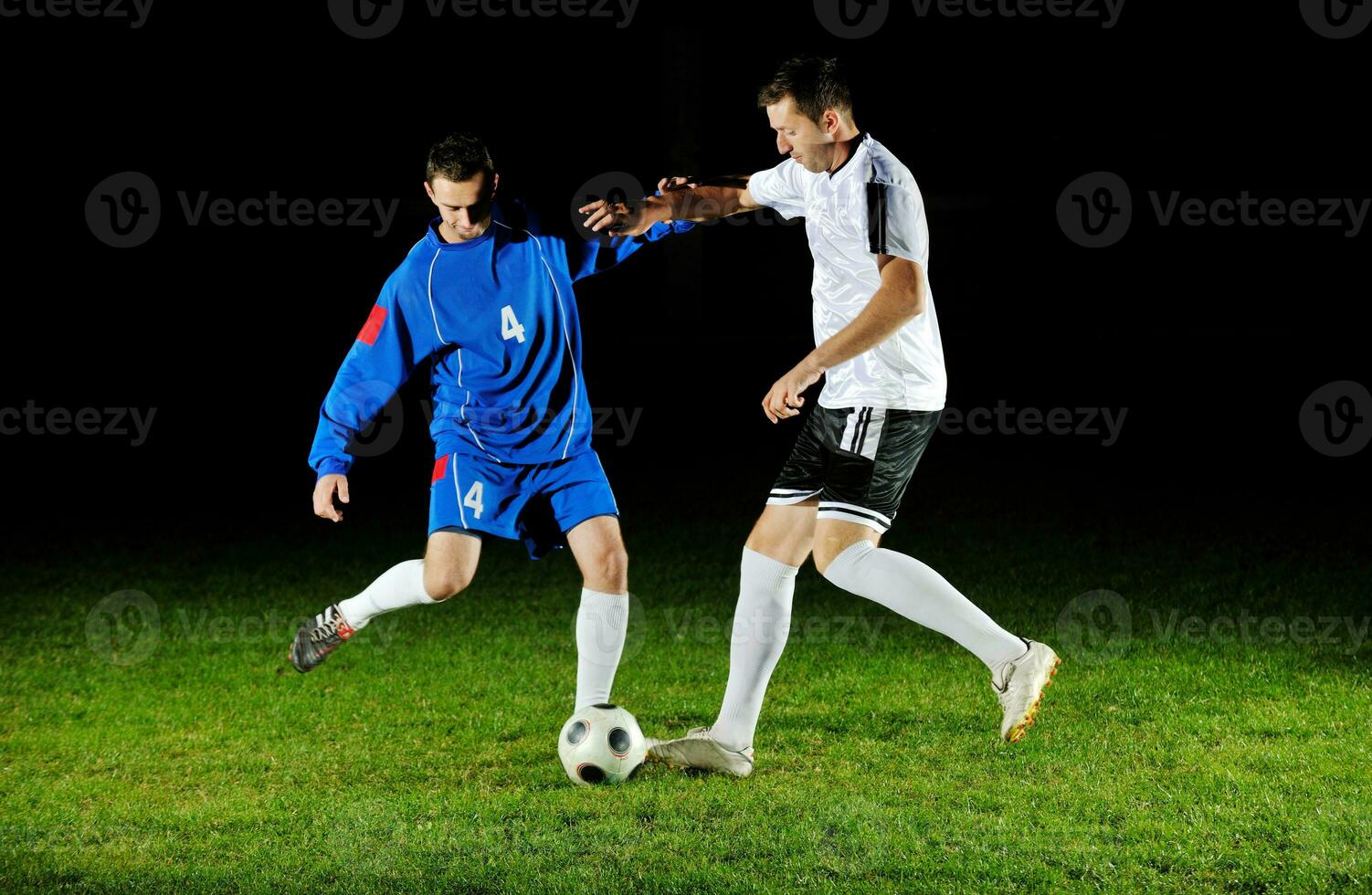 football players in action for the ball photo