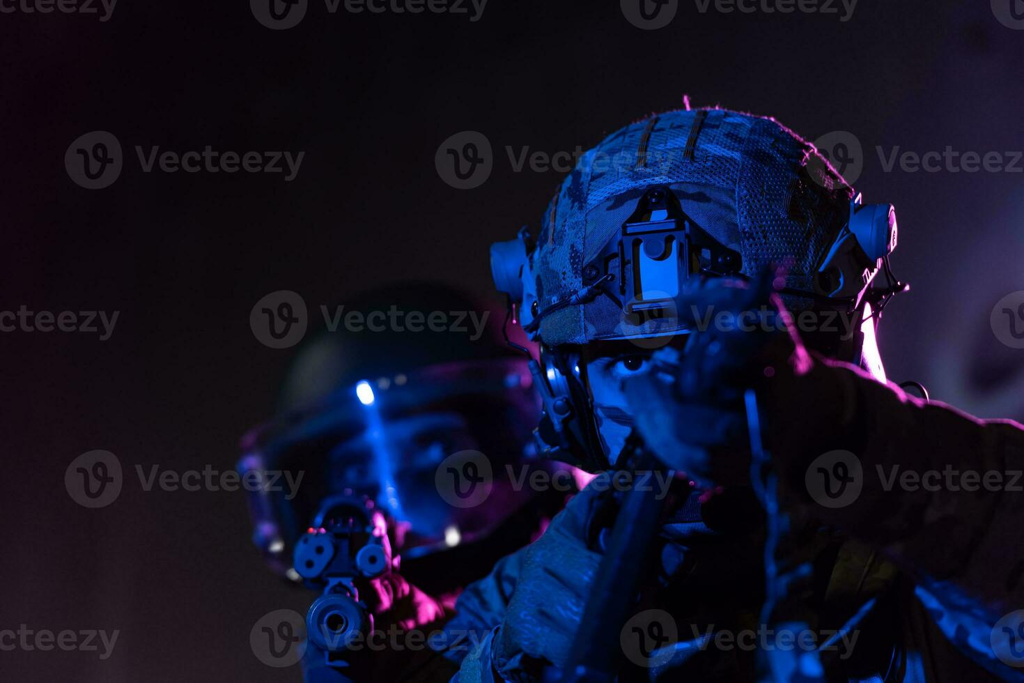 Modern warfare soldiers in dark with combat ammunition and weapons in the hands of equipped laser sights are in battle order. Mixed media. photo