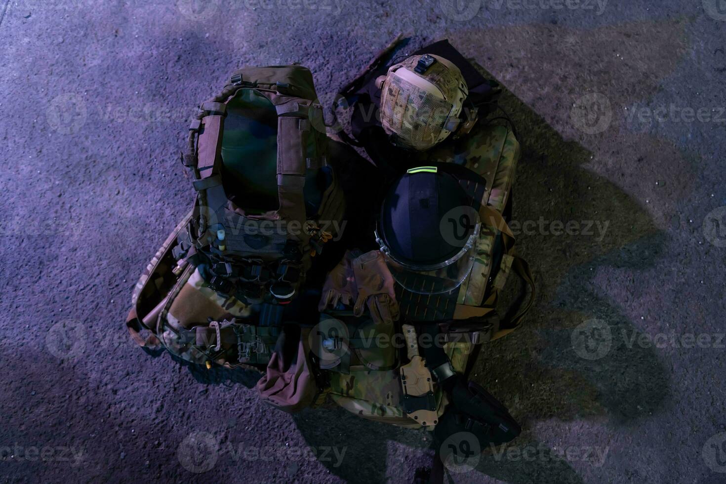Army body armor, helmet and ammunition, Kalashnikov assault rifle with matrons and first aid tourniquet composition on brown wood. Army body armor. flat laying. military concept. photo
