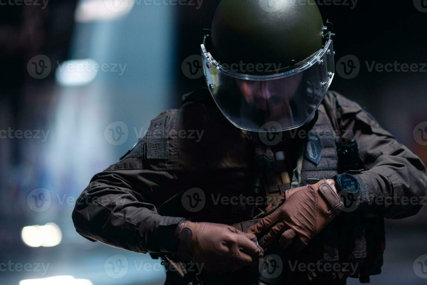 Army soldier in Combat Uniforms with an assault rifle and combat helmet night mission dark background. Blue and purple gel light effect. photo
