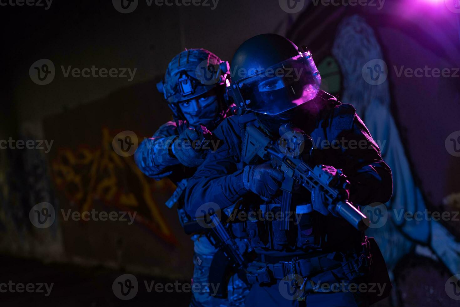 Modern warfare soldiers in dark with combat ammunition and weapons in the hands of equipped laser sights are in battle order. Mixed media. photo