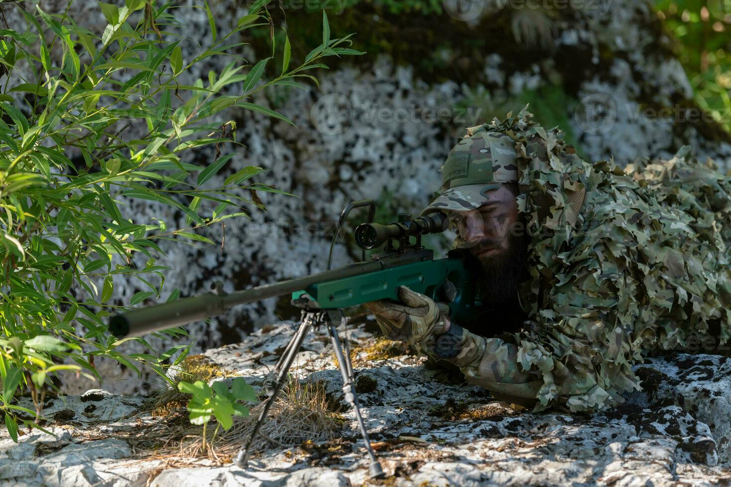 army soldier holding sniper rifle with scope and aiming in forest. war, army, technology and people concept photo