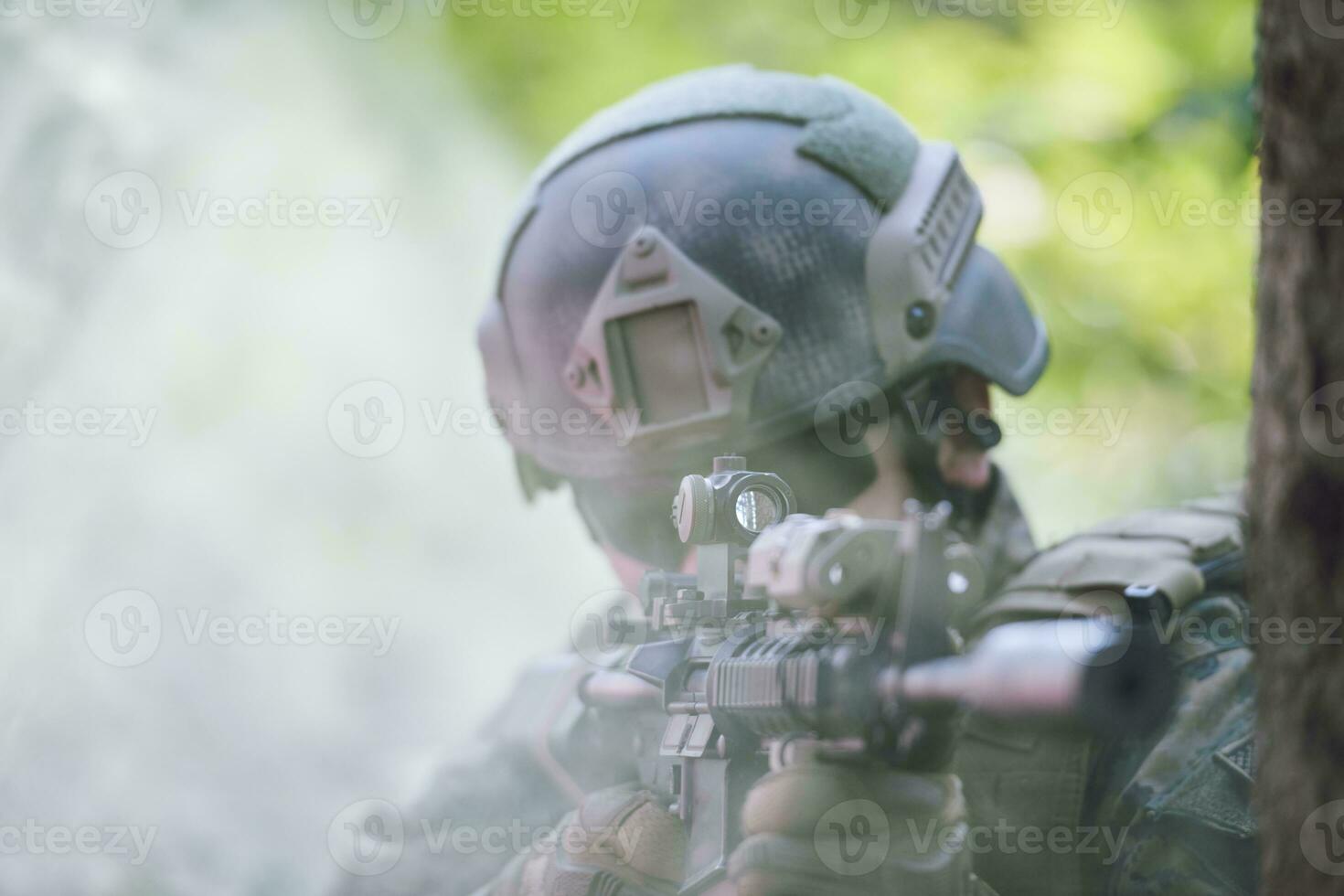 soldier in action aiming  on weapon  laser sight optics photo