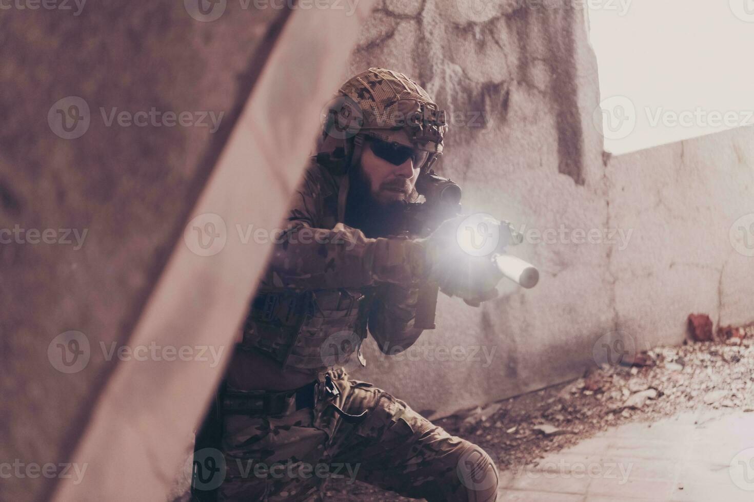 A bearded soldier in uniform of special forces in a dangerous military action in a dangerous enemy area. Selective focus photo