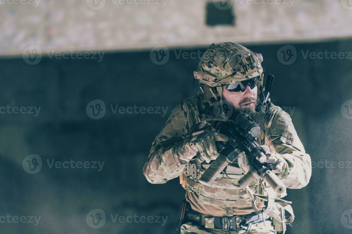 A bearded soldier in uniform of special forces in a dangerous military action in a dangerous enemy area. Selective focus photo