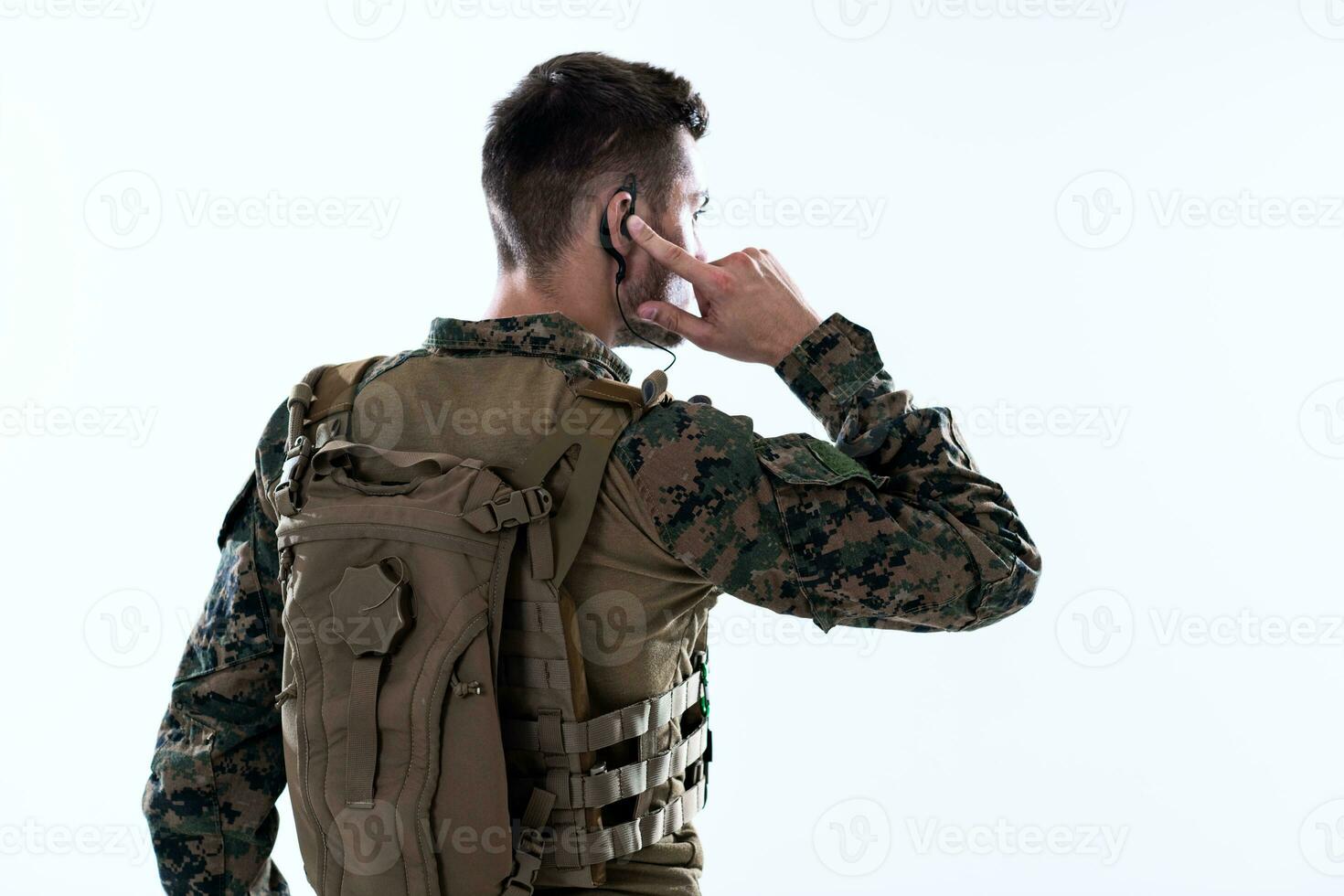 soldier preparing gear for action and checking communication photo