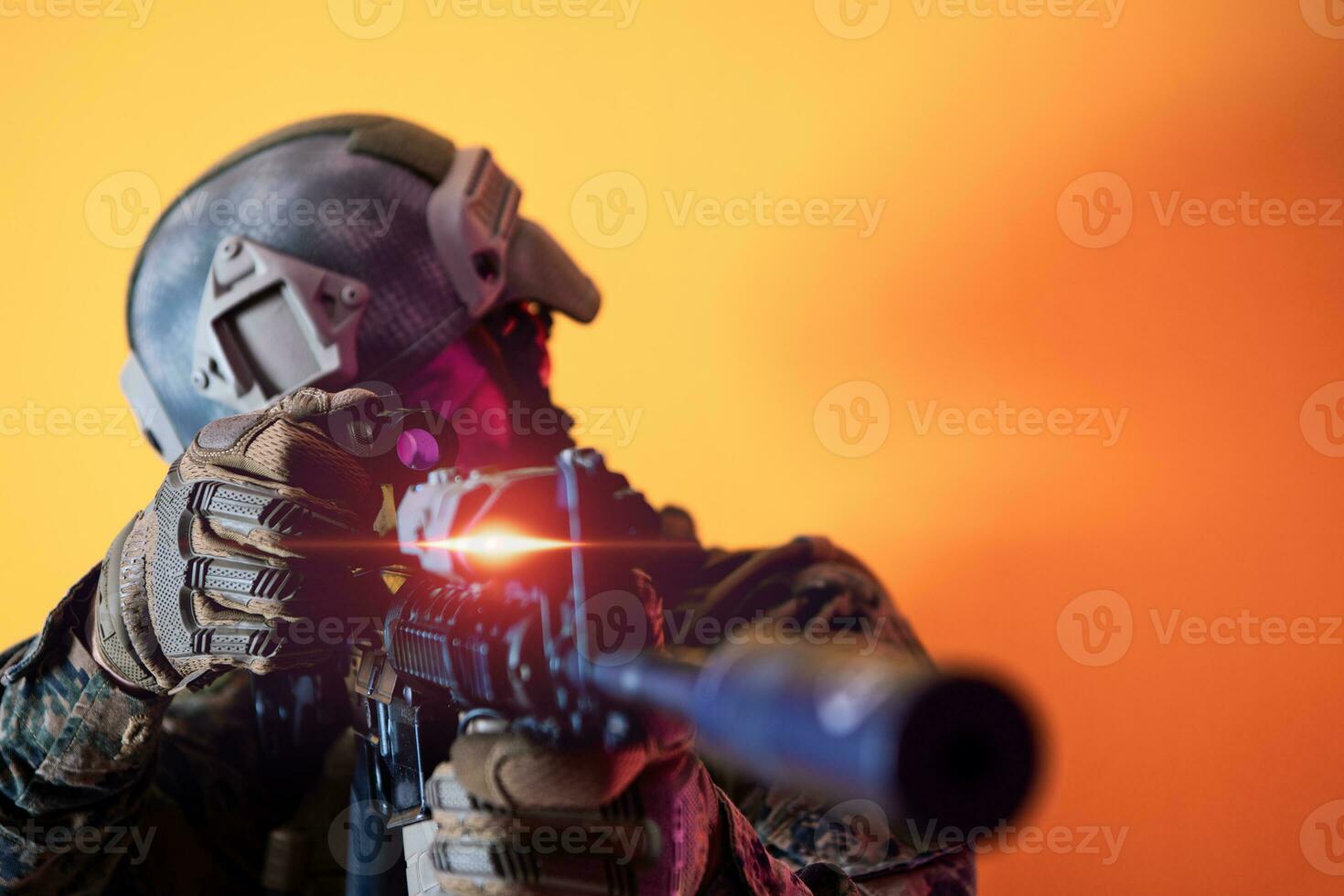 soldier in action aiming laseer sight optics yellow background photo