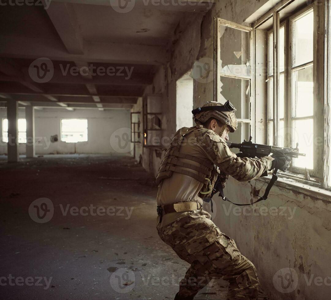 soldier in action near window changing magazine and take cover photo