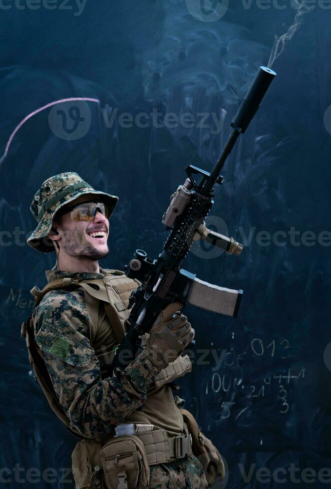 soldier firing into the air in front of black chalkboard photo