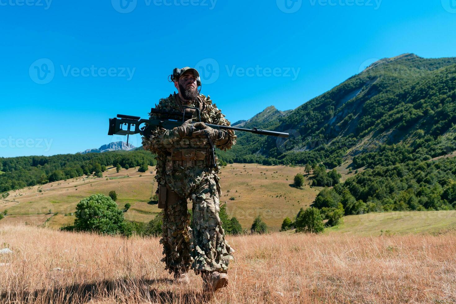 army soldier holding a sniper rifle with scope and walking in the forest. war, army, technology and people concept. photo