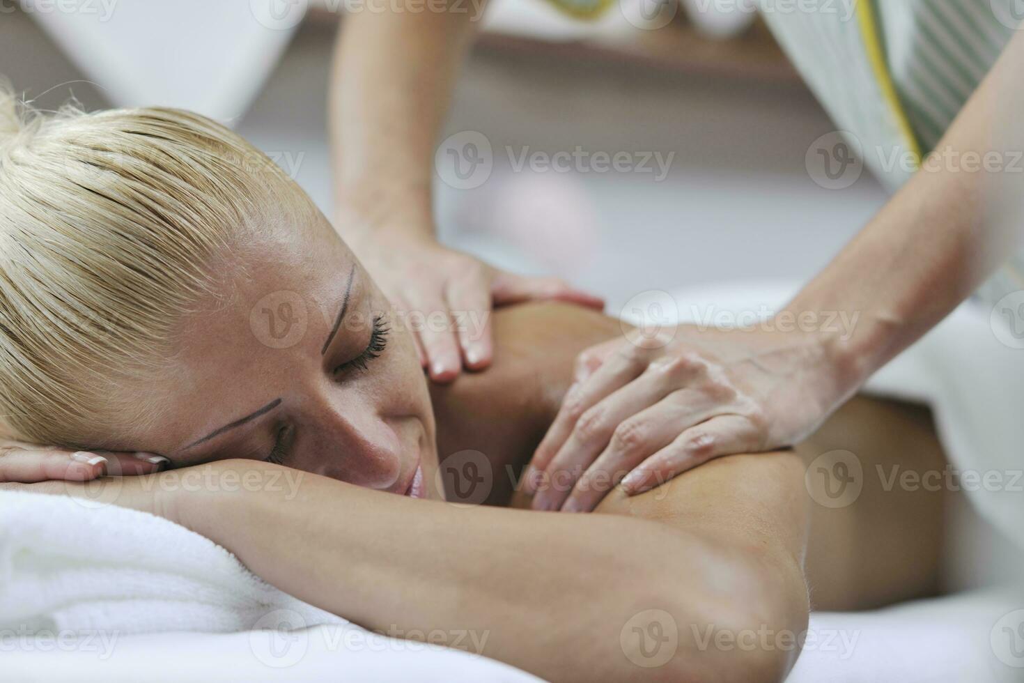 woman at spa and wellness back massage photo