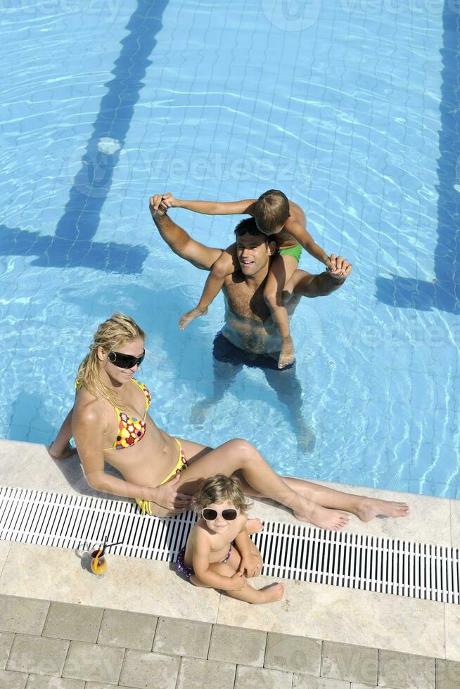 happy young family have fun on swimming pool photo