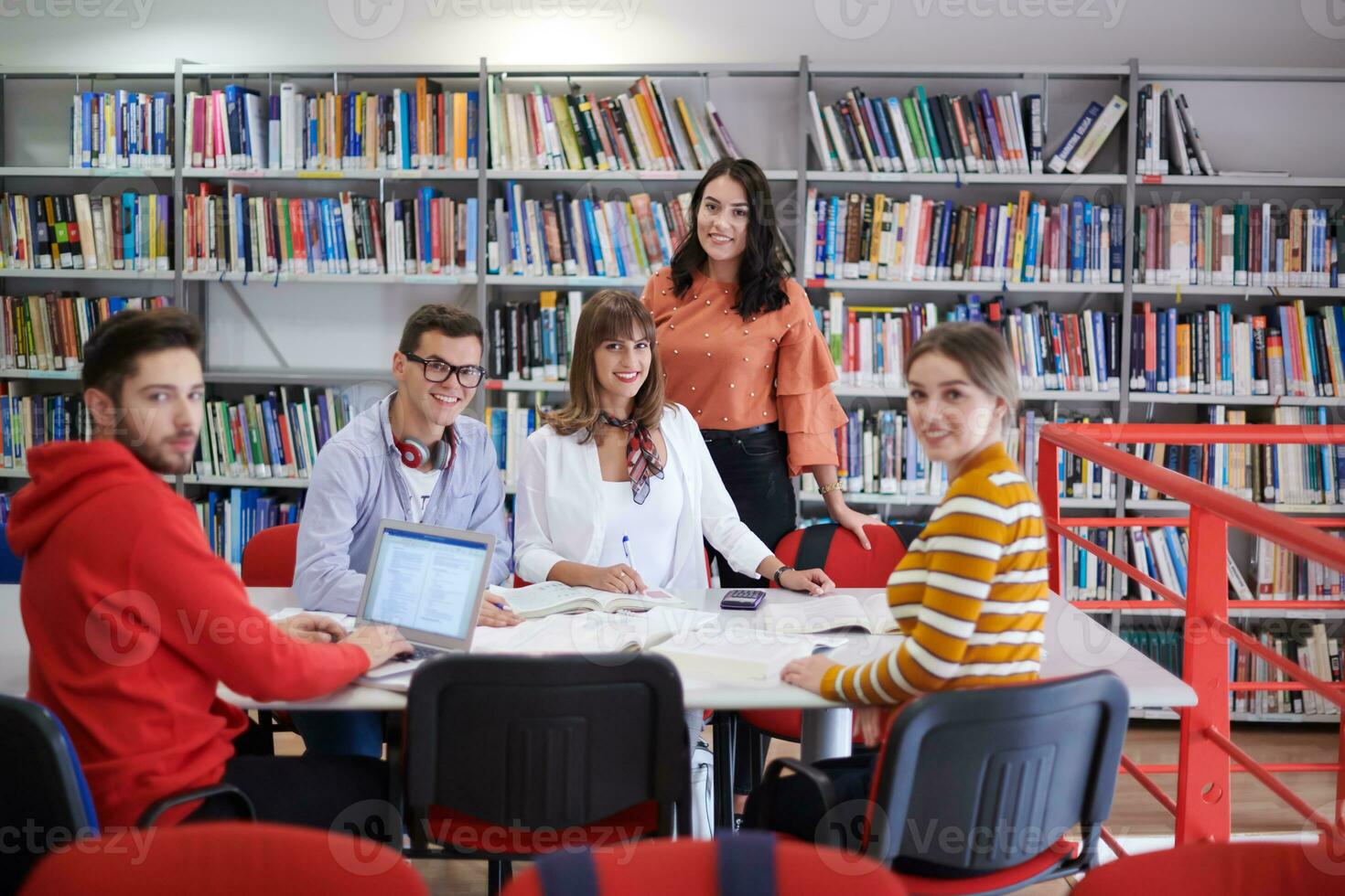 students group working on school project together on tablet computer at modern university photo