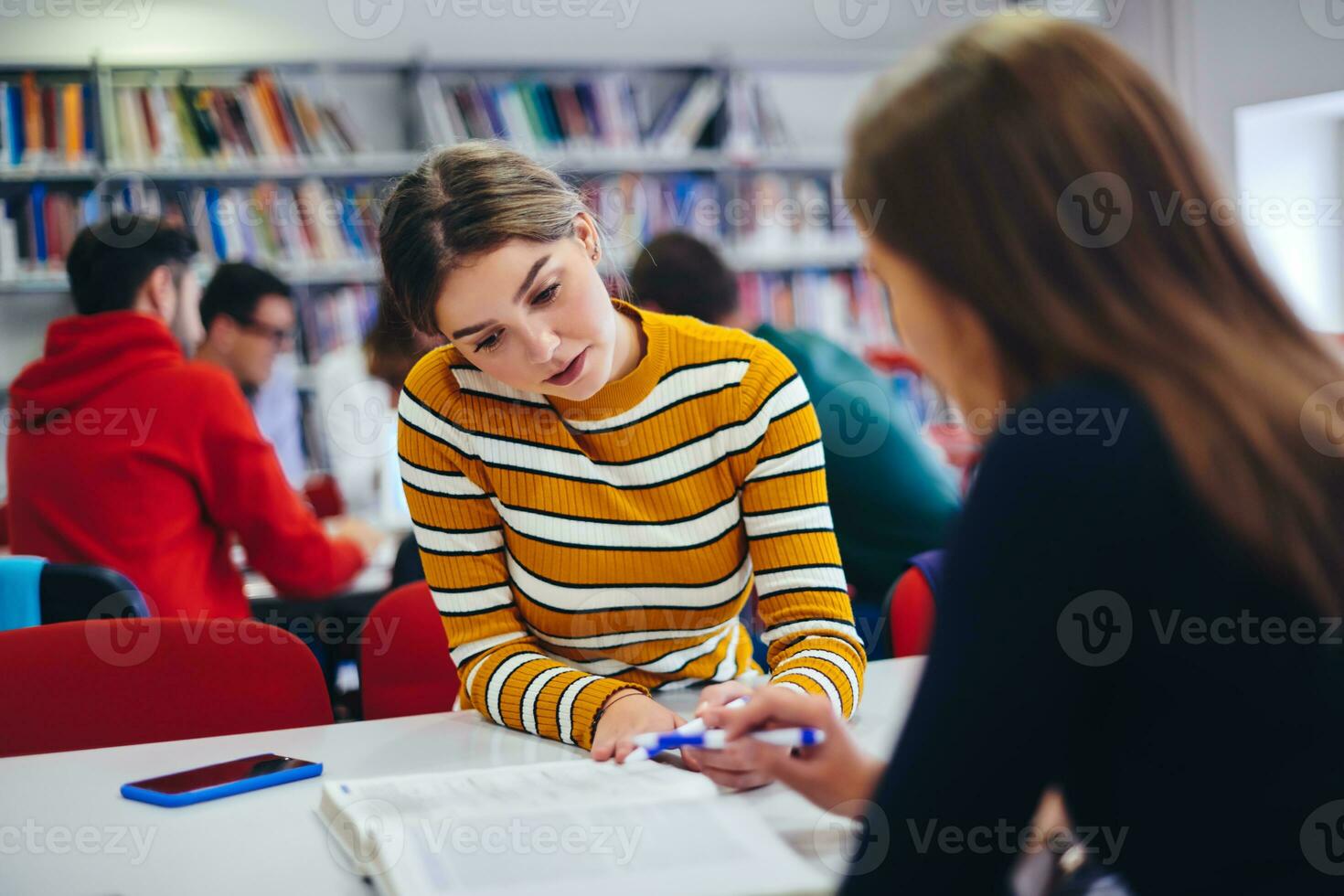 students group working on school project together on tablet computer at modern university photo