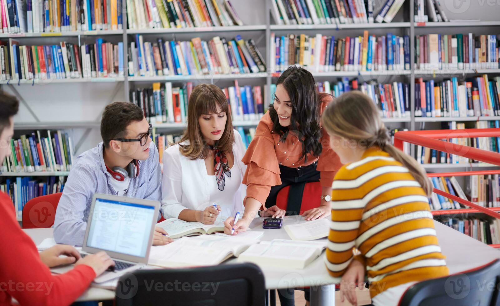 students group working on school project together on tablet computer at modern university photo