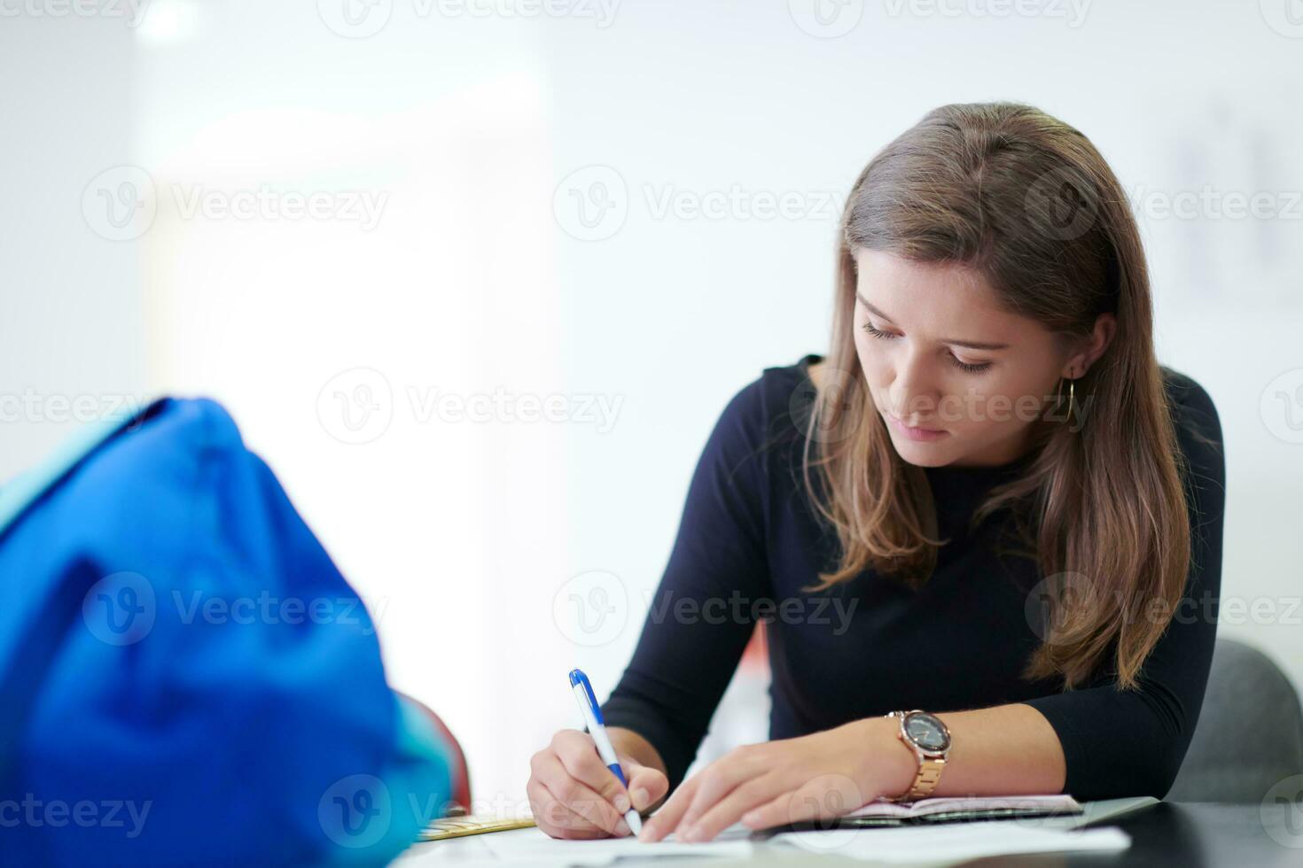 student taking notes for school class photo