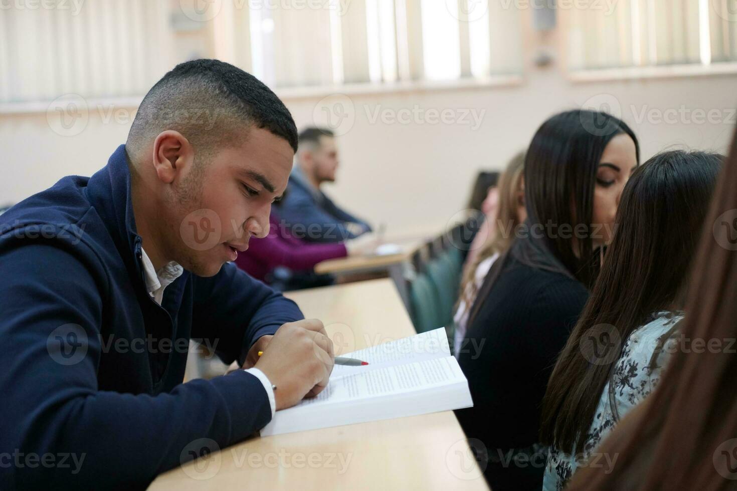 student taking notes while studying in high school photo