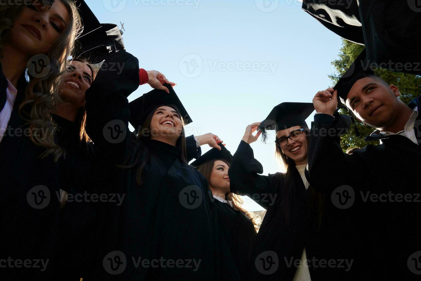 Group of diverse international graduating students celebrating photo