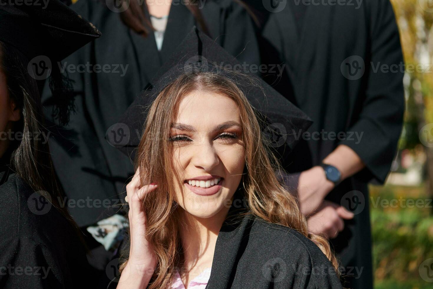 Group of diverse international graduating students celebrating photo