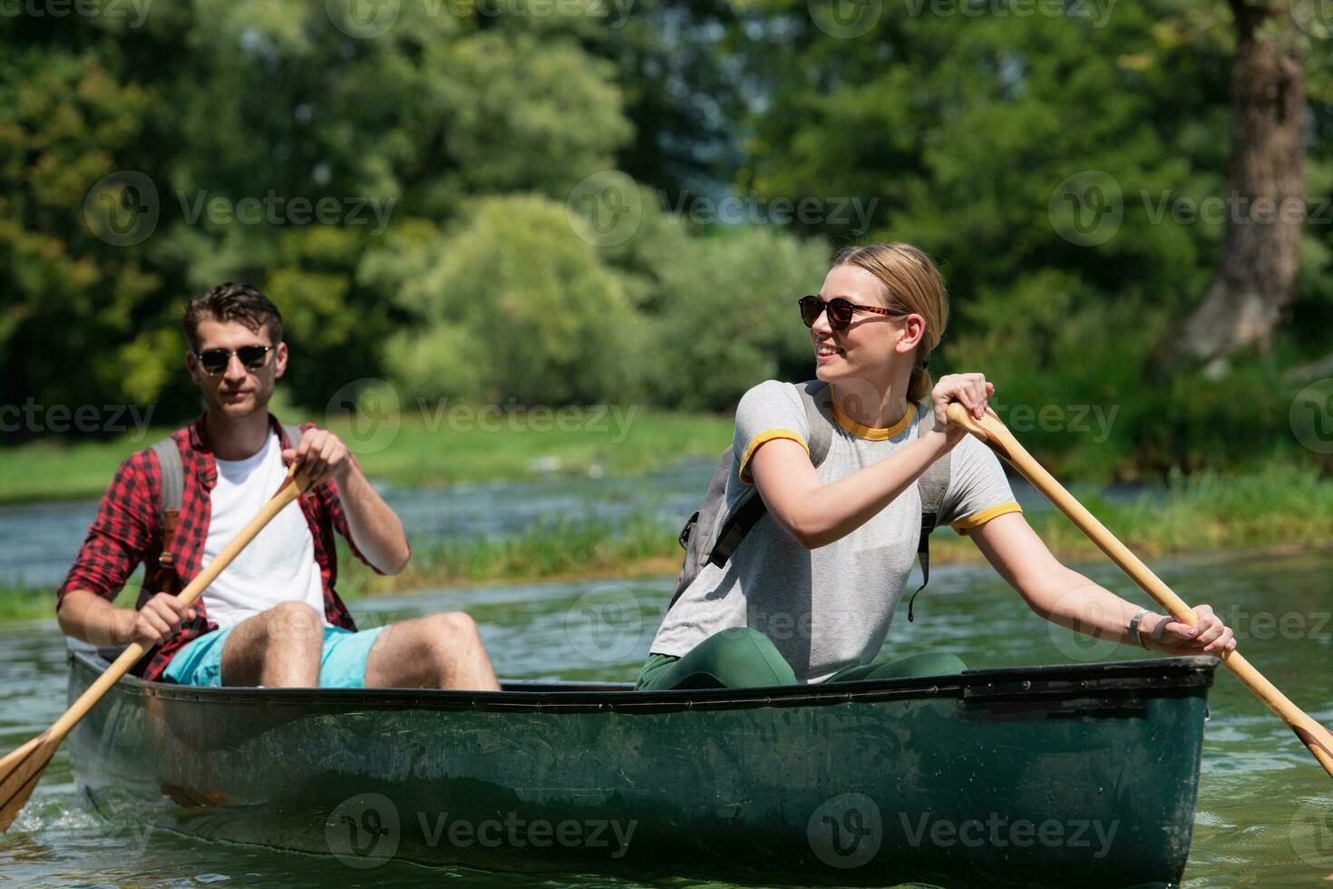couple of explorers conoining on wild river photo