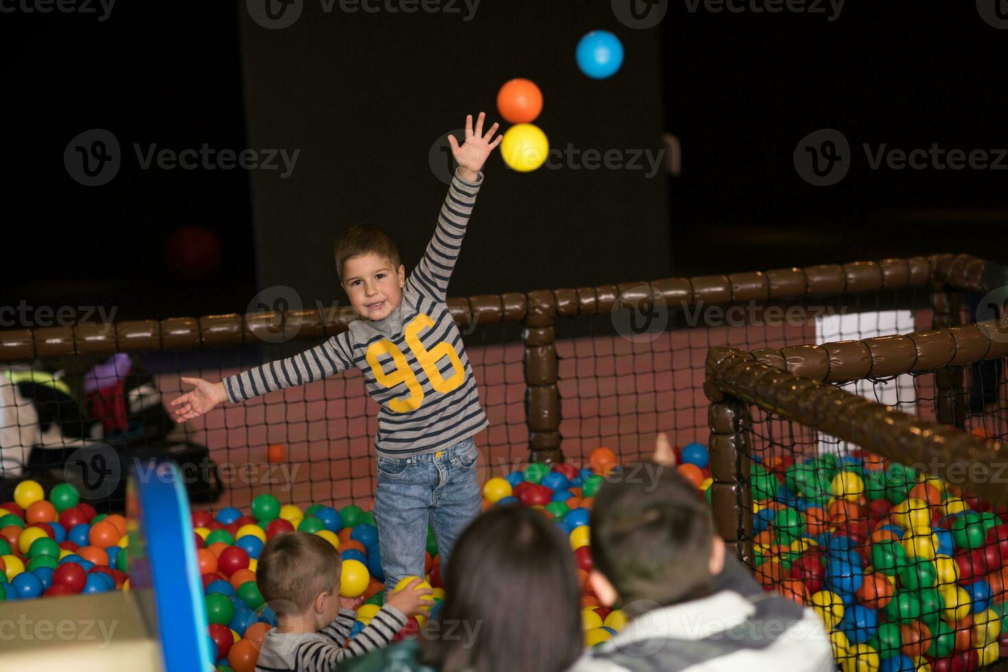 young parents with kids in a children's playroom photo