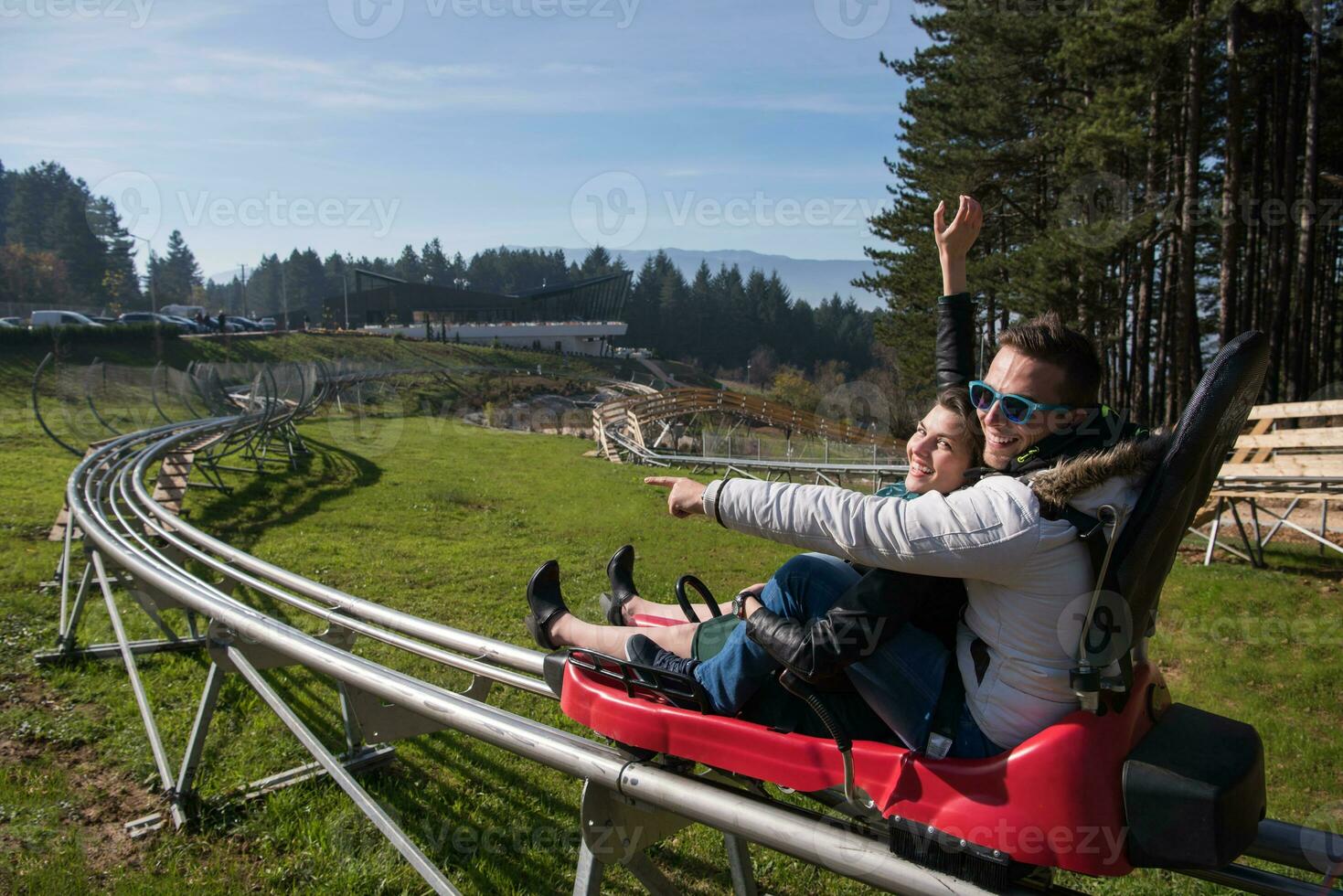 couple enjoys driving on alpine coaster photo