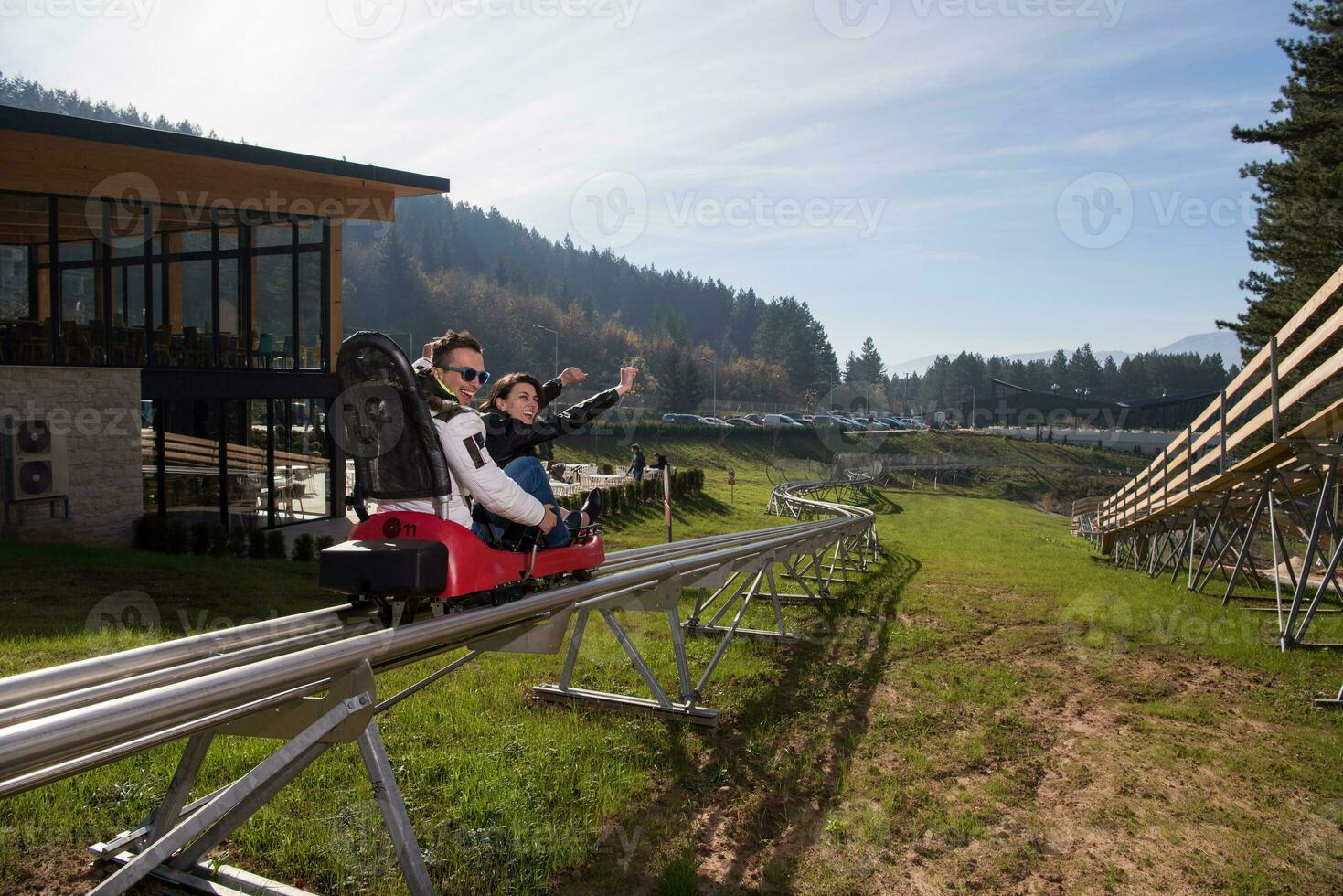 couple enjoys driving on alpine coaster photo