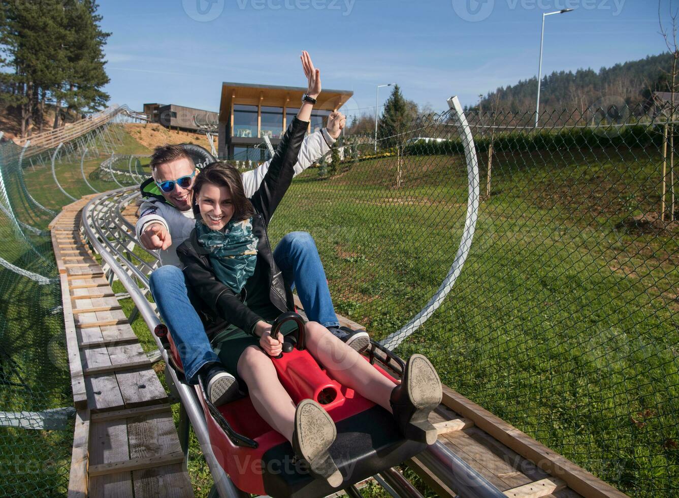 couple enjoys driving on alpine coaster photo