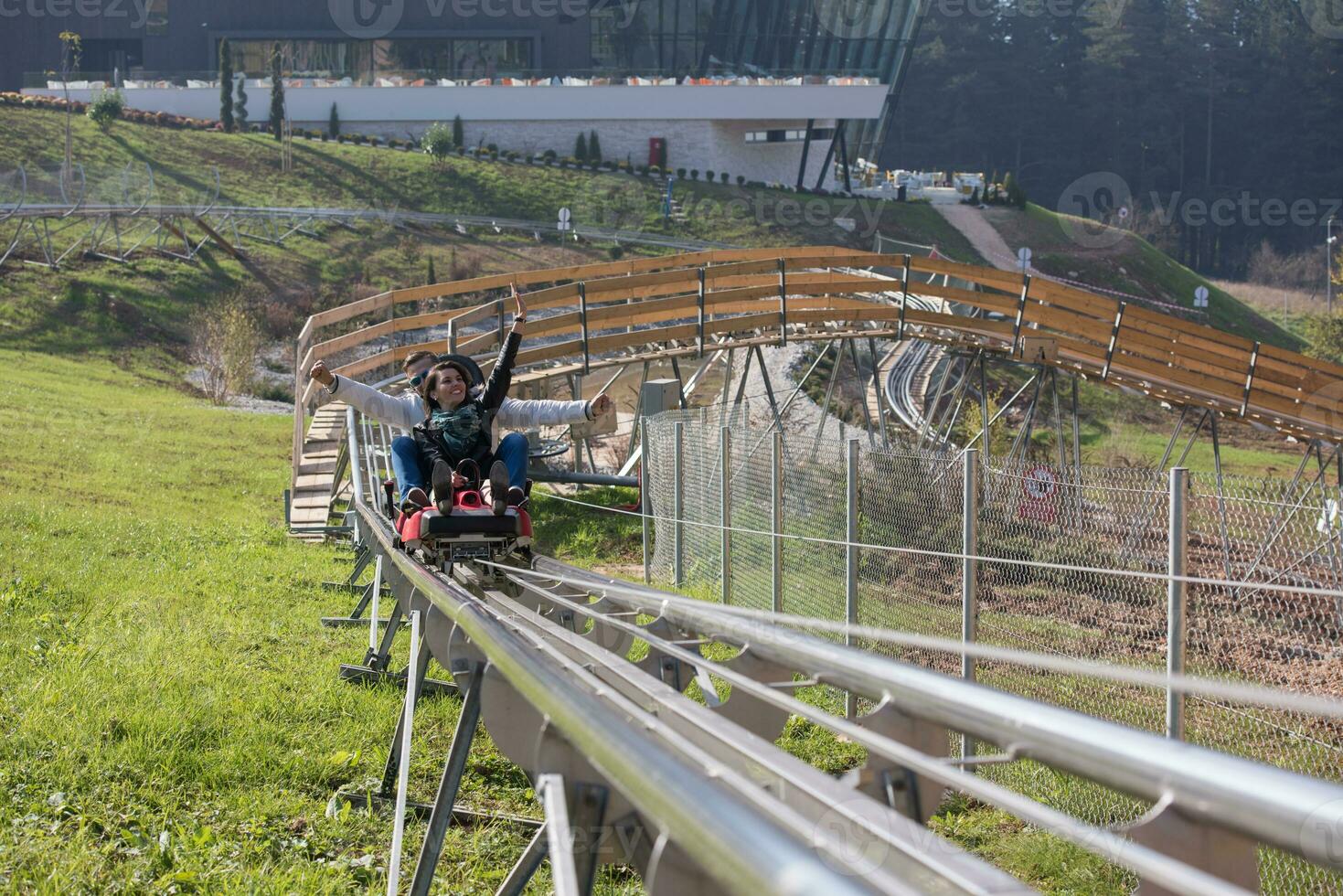 couple enjoys driving on alpine coaster photo