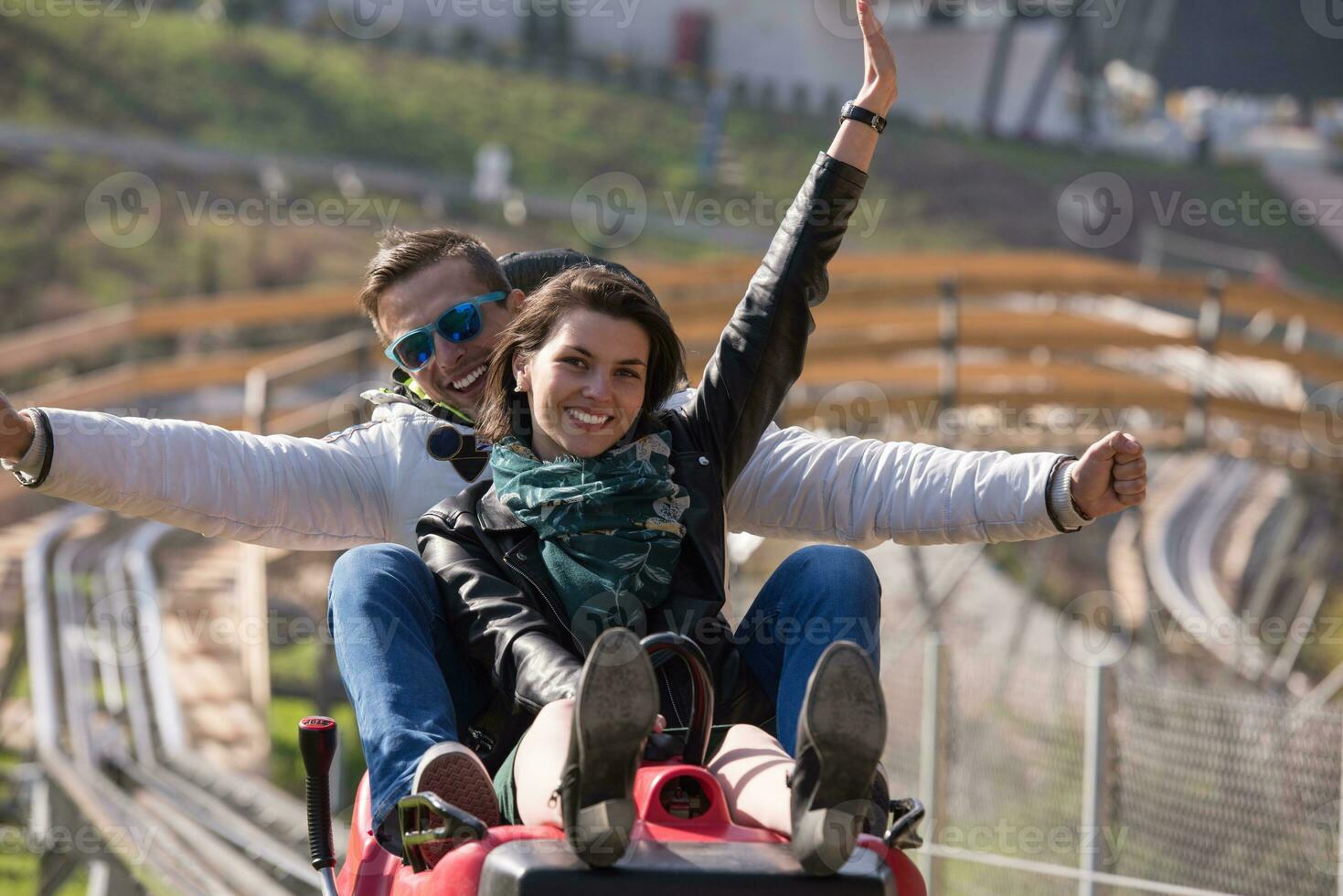 couple enjoys driving on alpine coaster photo