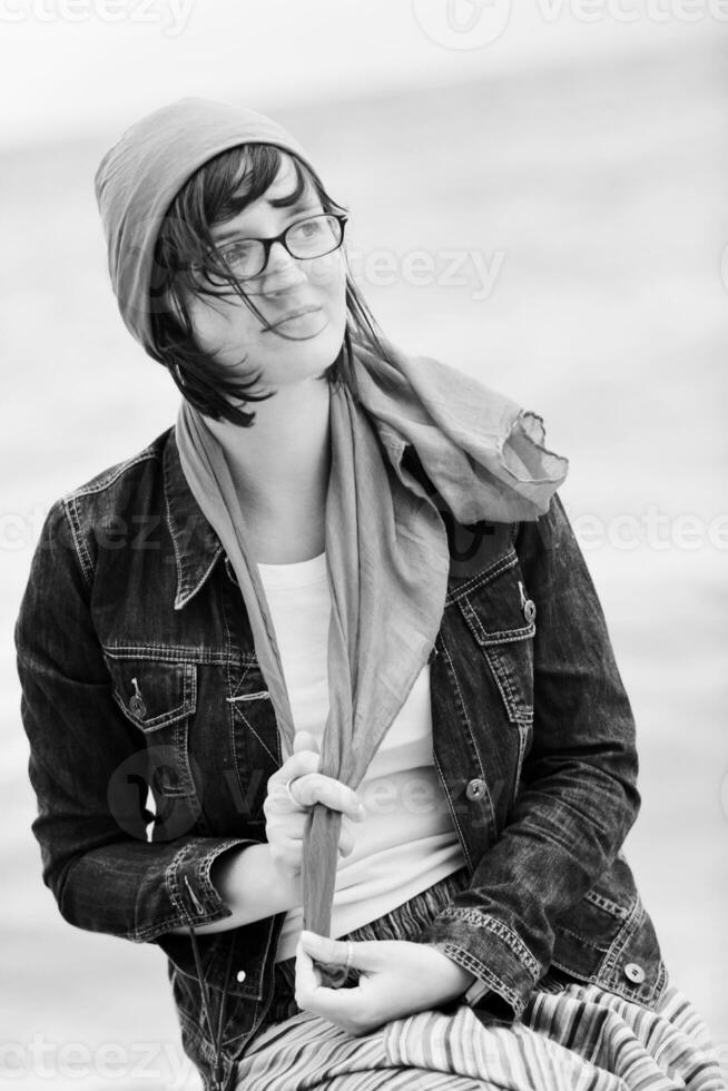 beautiful young woman on beach with scarf photo