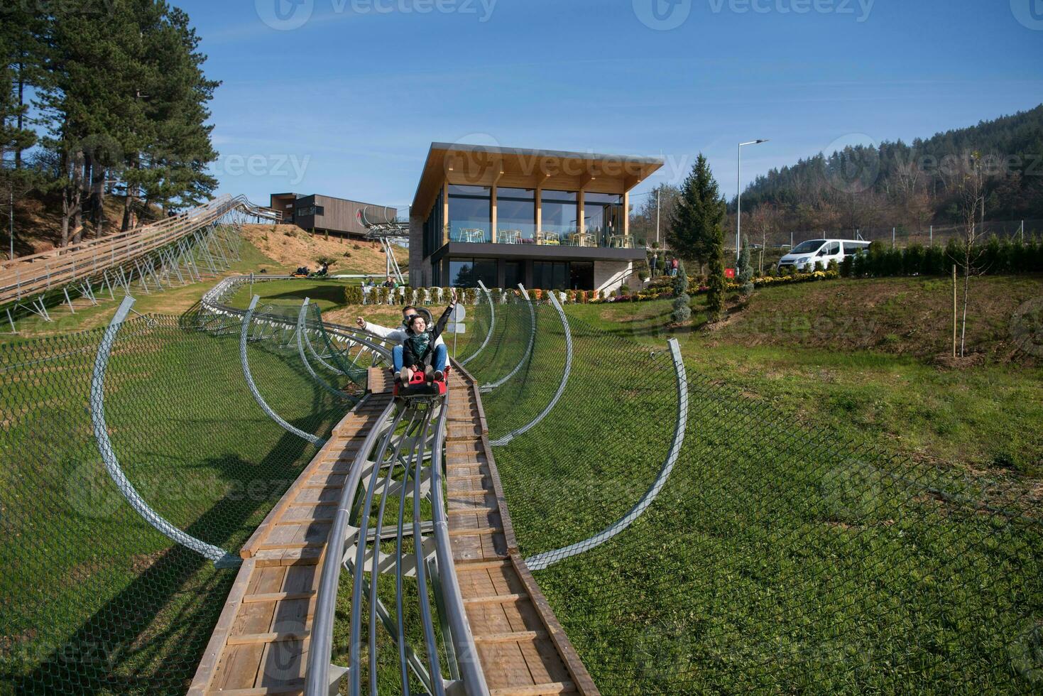 couple enjoys driving on alpine coaster photo