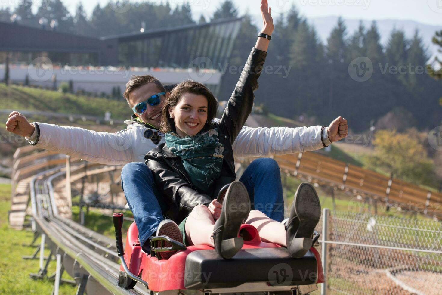 couple enjoys driving on alpine coaster photo