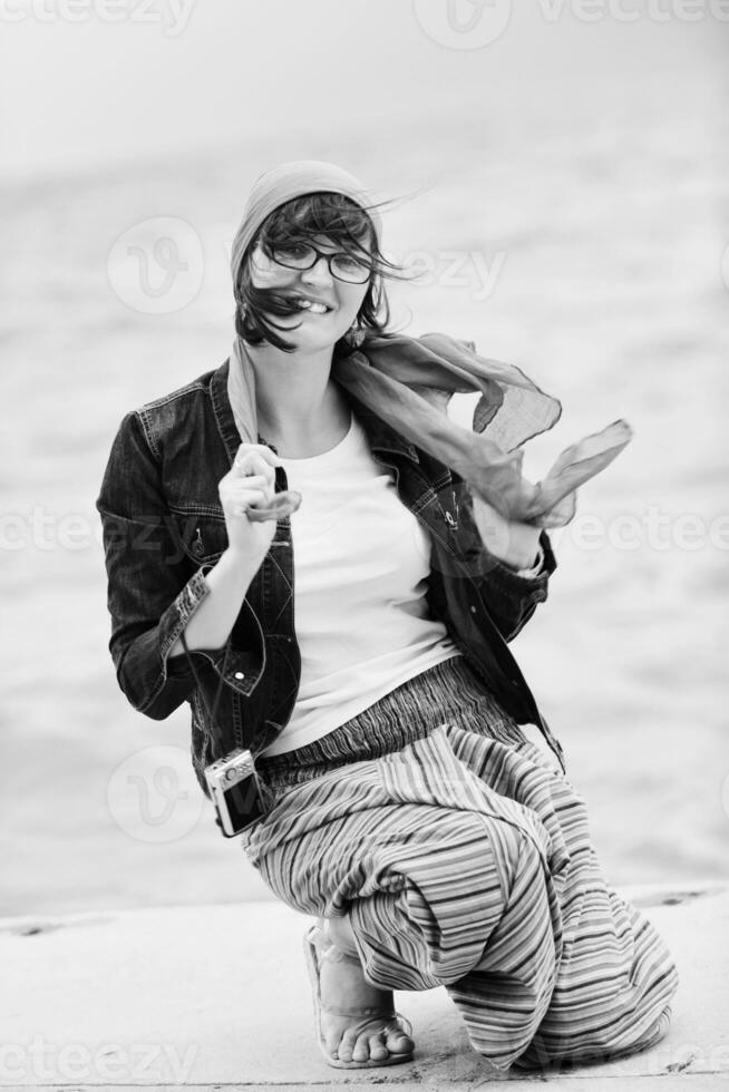 beautiful young woman on beach with scarf photo