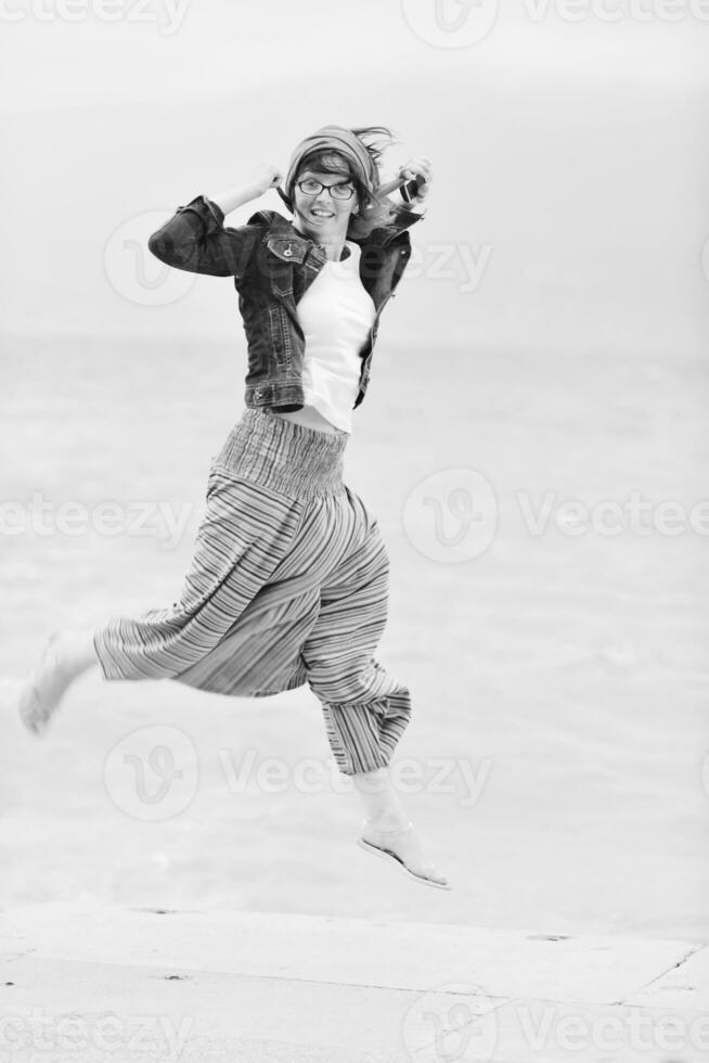 beautiful young woman on beach with scarf photo