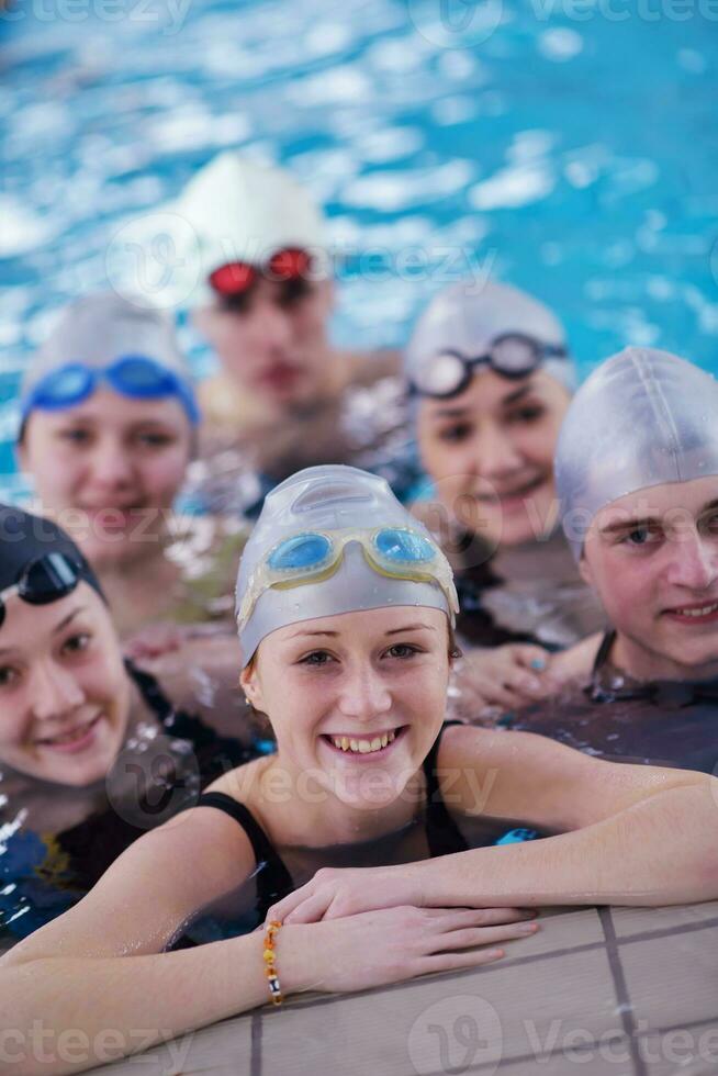 happy teen group  at swimming pool photo