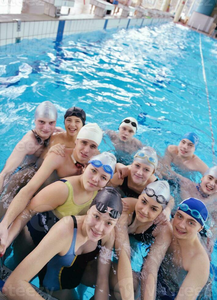 happy teen group  at swimming pool photo