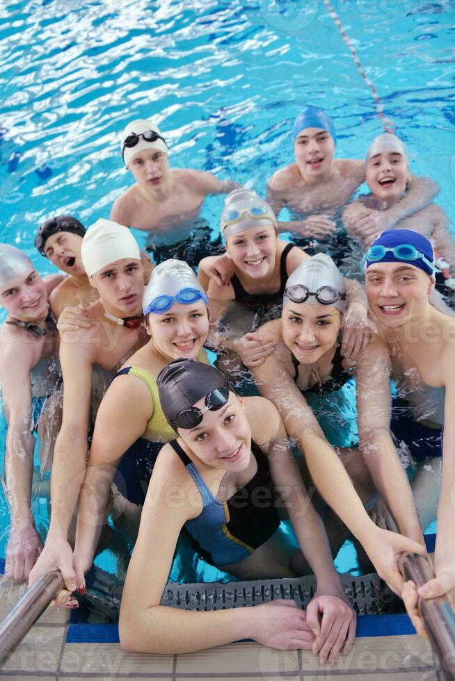 happy teen group  at swimming pool photo